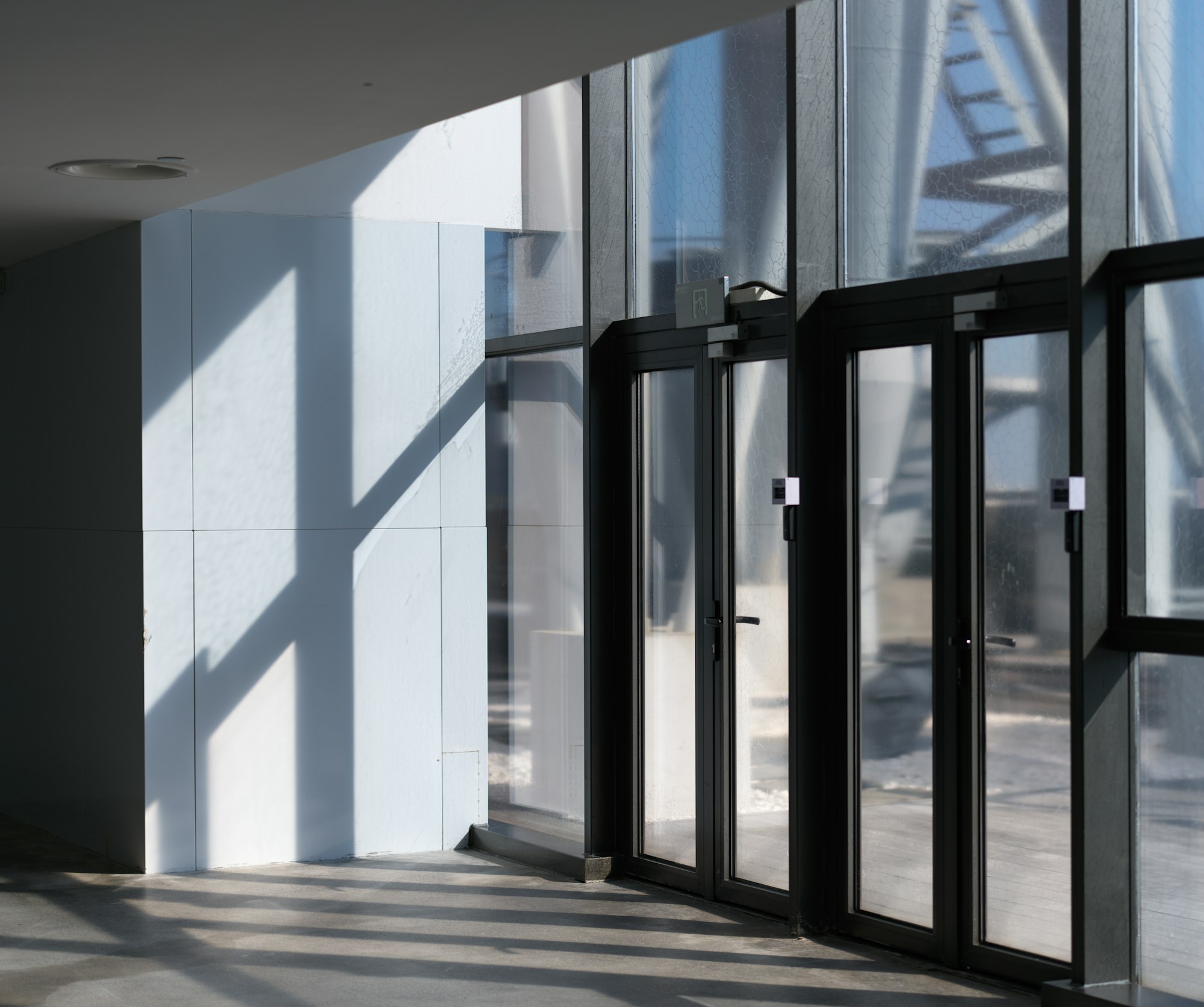 Glass office entrance doors with commercial push-bar hardware